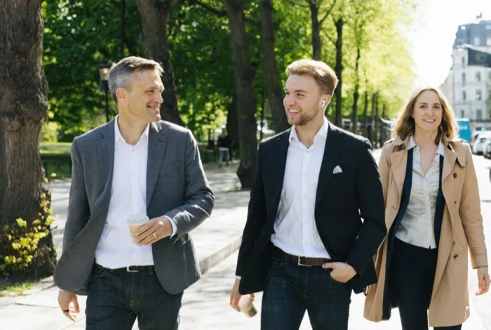 Three colleagues walking in a park